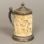 A 19th century carved ivory lidded tankard The tusk carved in the round with putti, birds,