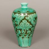 A Chinese Song porcelain chrysanthemum vase With scroll decoration on a turquoise ground.