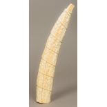 A late 19th/early 20th century carved tusk Worked in the round with a procession of figures.