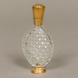 A 19th century Continental gold mounted cut clear glass scent bottle Of flattened ovoid form with
