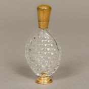 A 19th century Continental gold mounted cut clear glass scent bottle Of flattened ovoid form with