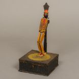 An early 20th century speaker box automaton Formed as a painted carved wooden Negro figure dancing