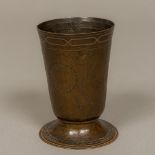 An Arts & Crafts copper footed beaker Etched in round with various heraldic crests,