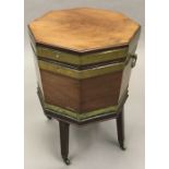 An early 19th century mahogany cellaret Of brass bound octagonal form with hinged lid enclosing the