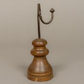 An antique rushnip The wrought iron brush holder mounted on a turned wooden plinth base.