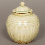 A Chinese Song Dynasty pottery pot and cover With lapette carved decoration and all over celadon