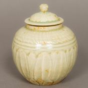 A Chinese Song Dynasty pottery pot and cover With lapette carved decoration and all over celadon