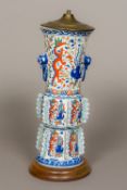 A Chinese porcelain lamp base Modelled as an archaistic twin handled vase with flanges. 43 cm high.