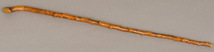 A 19th century Folk Art carved/engraved treen walking stick Decorated in the round with figures,