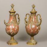 A pair of gilt metal mounted red marble baluster garniture vases and covers With floral swags and
