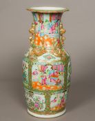 A 19th century Canton famille rose vase The flared neck rim above four gilt heightened dogs-of-fo