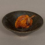 A Chinese Song Dynasty pottery bowl The interior decorated with a leaf print. 12 cm diameter.