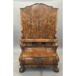 A 19th century Dutch burr walnut secretaire cabinet The top section with twin cupboard doors with