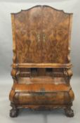 A 19th century Dutch burr walnut secretaire cabinet The top section with twin cupboard doors with