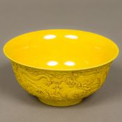 A Chinese yellow ground porcelain bowl The exterior decorated in the round with dragons chasing