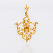 An Edwardian 15 ct gold citrine and seed pearl pendant Of pierced scrolling form,