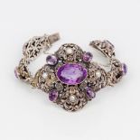 An amethyst and pearl set silver bracelet The links of pierced scrolling foliate form.