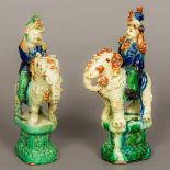 A pair of Chinese pottery figures modelled as courtly figures riding bedecked elephants Standing on