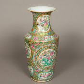 A 19th century Canton famille rose vase Decorated in the round with bird and floral filled