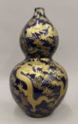 A Chinese blue ground double gourd gold splash vase