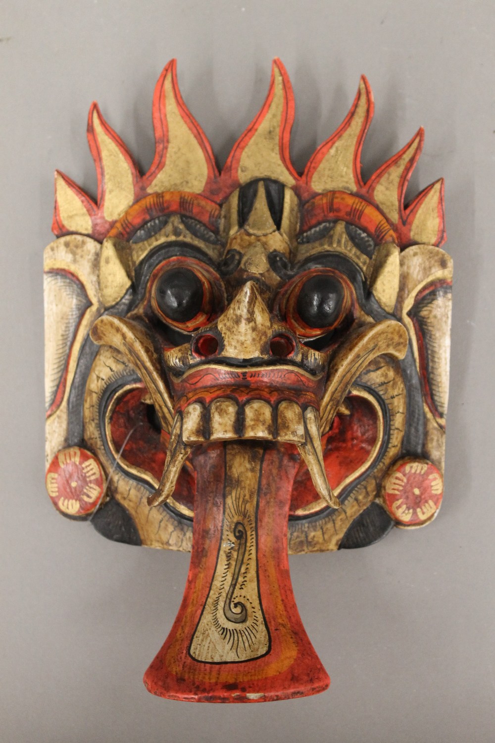 An Oriental carved wooden mask