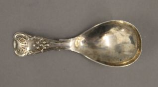 A silver caddy spoon