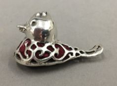 A silver pin cushion in the form of a duck