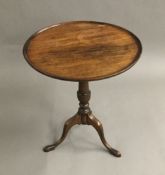 A mahogany low tripod table