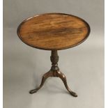 A mahogany low tripod table