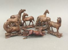 A collection of Oriental carved wooden horses