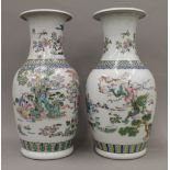 A pair of 20th century Chinese porcelain vases, hand painted with figures in a landscape,