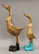 Two large wooden ducks in boots