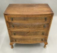 A 20th century bow front chest of drawers,