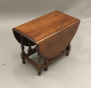 A small oak barley twist drop leaf coffee table