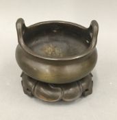 A Chinese bronze censer on stand. 11 cm diameter.