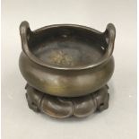 A Chinese bronze censer on stand. 11 cm diameter.