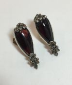 An unusual pair of antique cabochon garnet and rough cut diamond earrings,