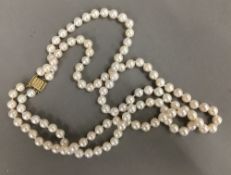 A well graded double row pearl necklace with 14 ct gold clasp,