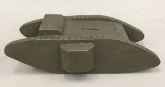 A painted wooden money box formed as a WWI tank