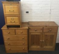 A modern pine chest of drawers, a modern pine side cupboard,