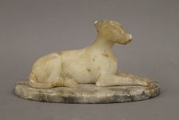 A 19th century alabaster model of greyhound. Greyhound 13 cm wide.