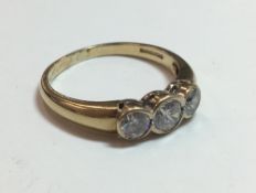 A 9 ct gold three stone dress ring, boxed (2.