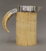 A Victorian silver mounted Asprey & Sons ivory and boars tusk jug. 27.