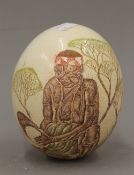 A carved and painted ostrich egg