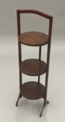 An early 20th century mahogany folding cake stand