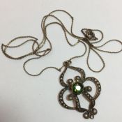 An Edwardian 9 ct gold, seed pearl and peridot pendant on a chain (the pendant 2.