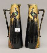 A pair of Frederick Rhead Art Nouveau pottery ewers. 30.5 cm high; 10.5 cm diameter.