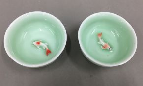 Two small porcelain bowls decorated with fish