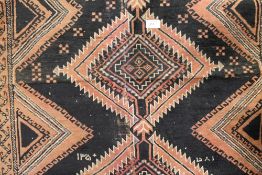 A black ground Caucasian rug