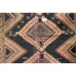 A black ground Caucasian rug